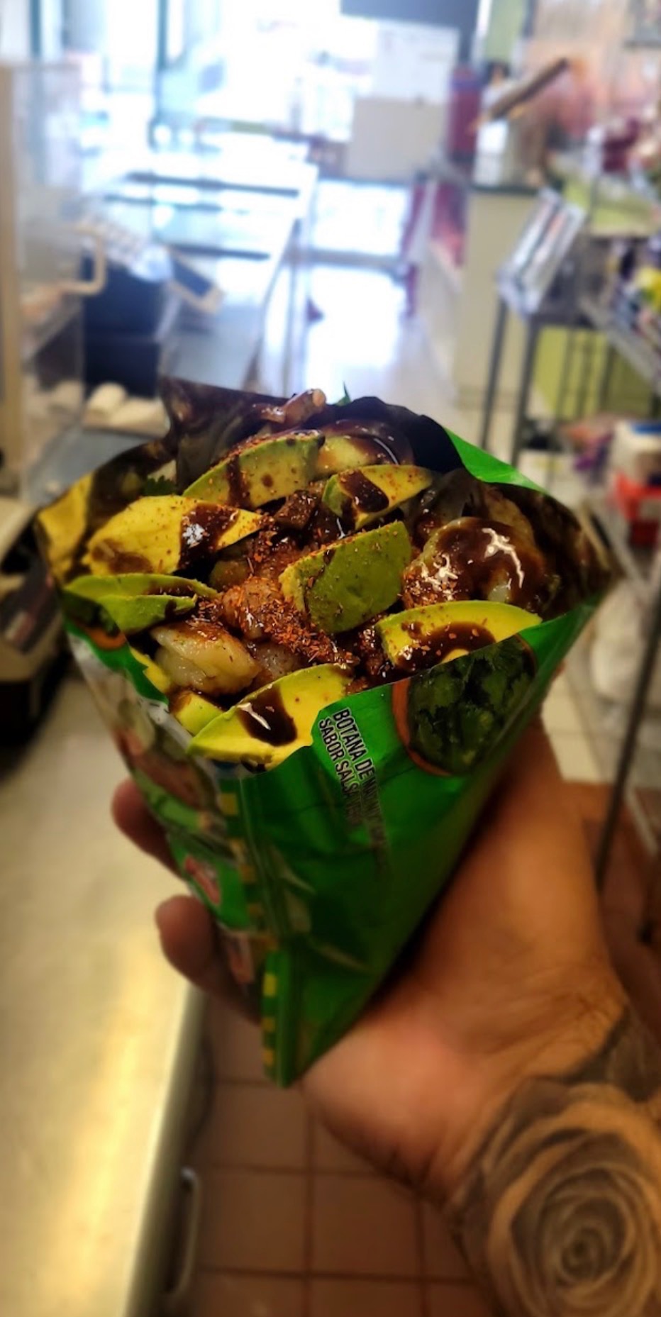 Avocado and fruit snack topped with sauce and chile