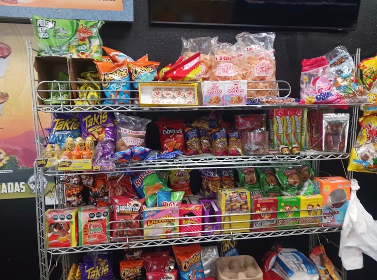Colorful packaged Mexican snacks displayed inside the shop